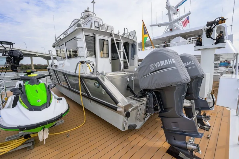 Slide: The Image of 2011 C & G Boatworks Explorer with Yamaha engines and a green jet ski on deck. - 12