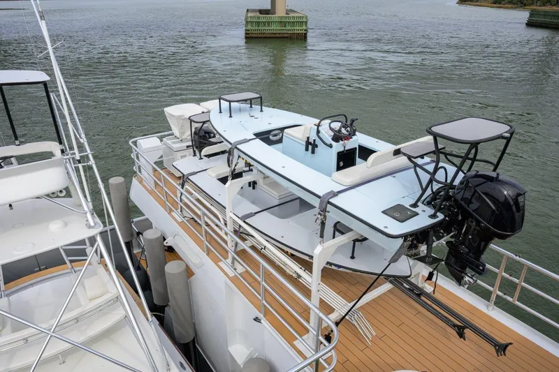 Slide: The Image of 2011 C & G Boatworks Explorer docked, featuring sleek design and powerful outboard motor. - 15