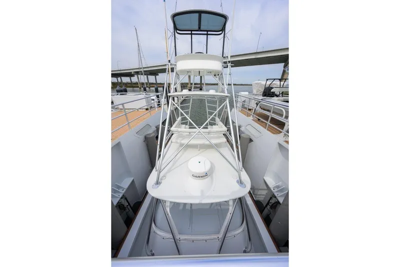 Slide: The Image of 2011 C & G Boatworks Explorer with tower, docked near a bridge. - 16