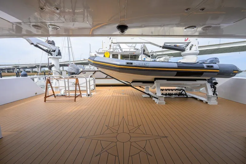 Slide: The Image of 2011 C & G Boatworks Explorer with tender on spacious deck, featuring compass rose design. - 19