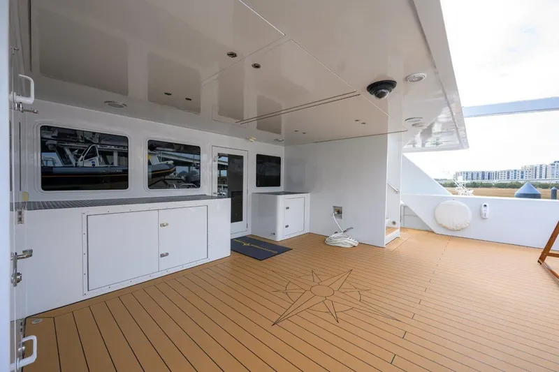 Slide: The Image of Spacious deck of 2011 C & G Boatworks Explorer with wood flooring and storage cabinets. - 20