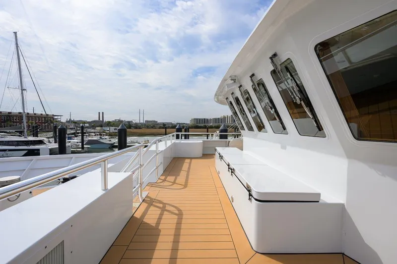 Slide: The Image of 2011 C & G Boatworks Explorer yacht deck with marina view, clear sky, and modern design. - 23