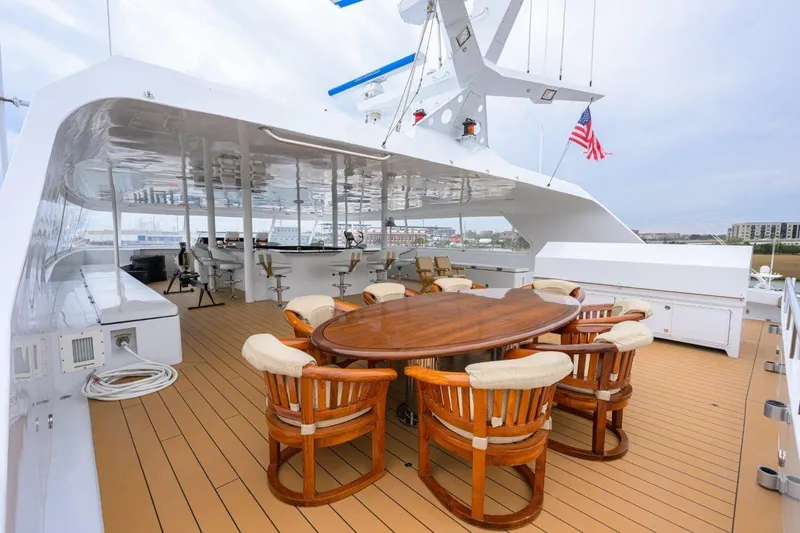 Slide: The Image of Luxurious 2011 C & G Boatworks Explorer yacht deck with elegant seating and dining area. - 29