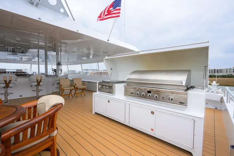 Slide: The Image of Luxury yacht deck with grill, seating, and American flag; 2011 C & G Boatworks Explorer. - 31