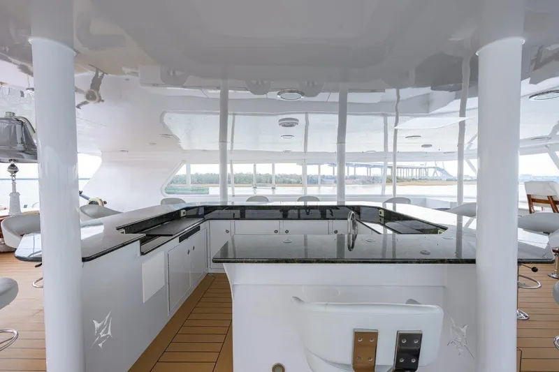 Slide: The Image of Luxurious 2011 C & G Boatworks Explorer yacht interior with sleek bar and seating area. - 34