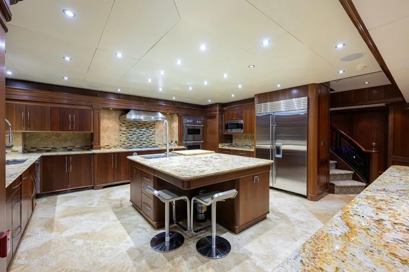 Slide: The Image of Luxurious yacht kitchen with granite countertops, stainless steel appliances, and elegant wood cabinetry. - 45