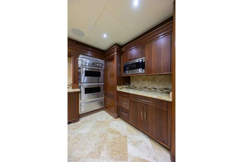 Slide: The Image of Luxurious kitchen in 2011 C & G Boatworks Explorer yacht with wood cabinetry and modern appliances. - 46