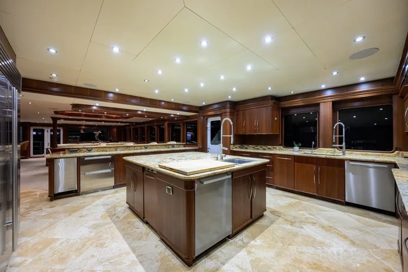 Slide: The Image of Luxurious yacht kitchen interior with wooden cabinetry, marble countertops, and modern lighting, C & G Boatworks Explorer 2011. - 47