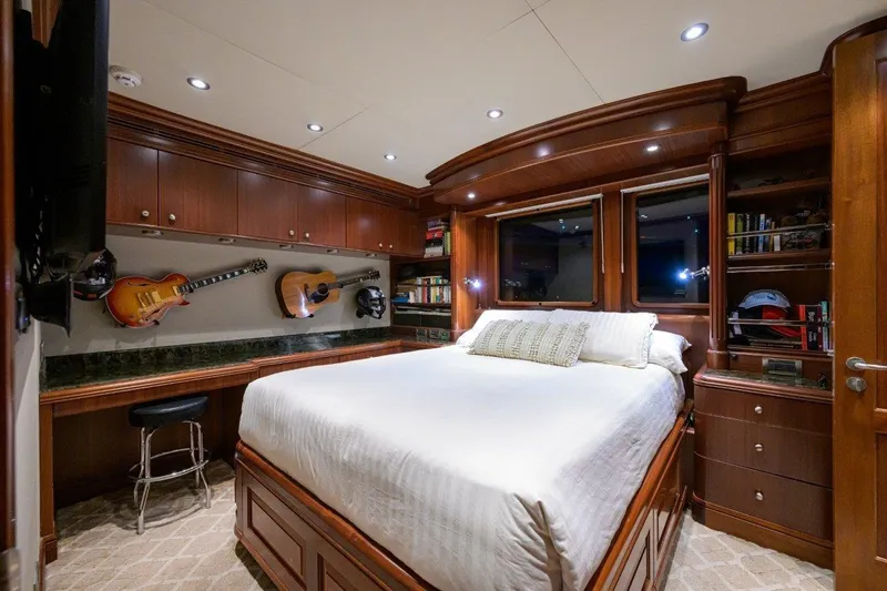 Slide: The Image of Luxurious 2011 C & G Boatworks Explorer bedroom with guitars, wood cabinetry, and cozy lighting. - 66