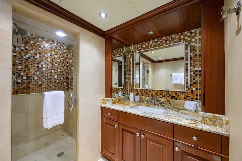 Slide: The Image of Luxurious yacht bathroom with mosaic tiles, granite countertop, and glass shower in 2011 C & G Boatworks Explorer. - 71