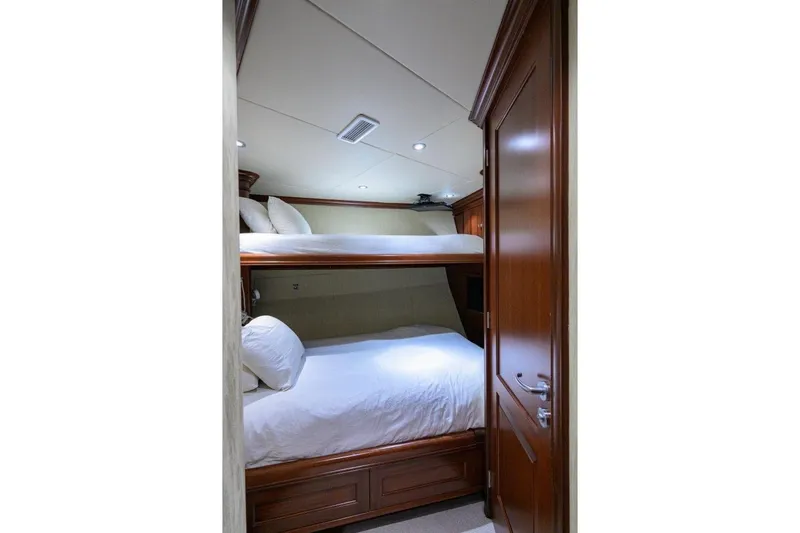 Slide: The Image of 2011 C & G Boatworks Explorer cabin with wooden bunk beds and white bedding. - 72