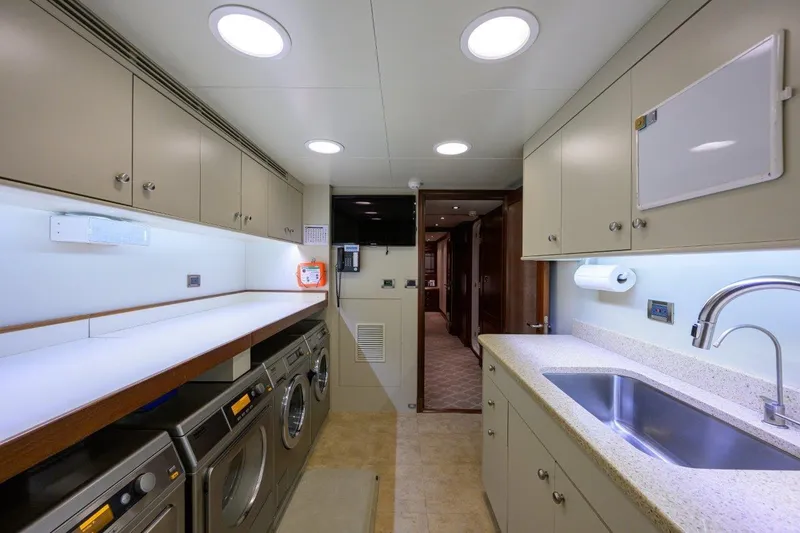 Slide: The Image of Laundry and utility room in 2011 C & G Boatworks Explorer yacht, featuring modern appliances. - 80