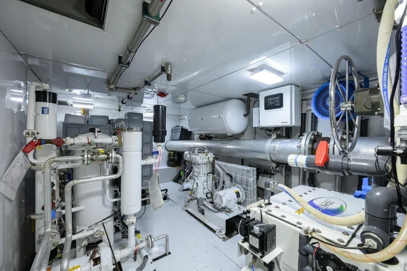 Slide: The Image of Engine room of 2011 C & G Boatworks Explorer, featuring complex machinery and piping systems. - 83