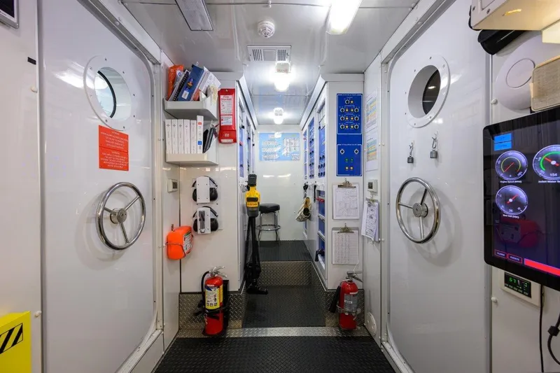 Slide: The Image of Interior of 2011 C & G Boatworks Explorer, featuring control panels and safety equipment. - 86