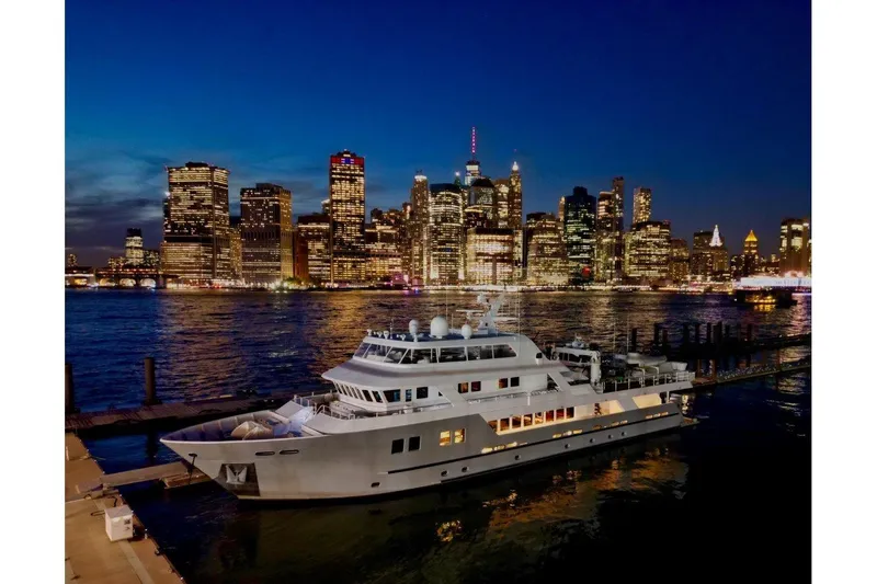 Slide: The Image of Luxury yacht "Explorer" by C & G Boatworks, 2011, docked with city skyline at night. - 87