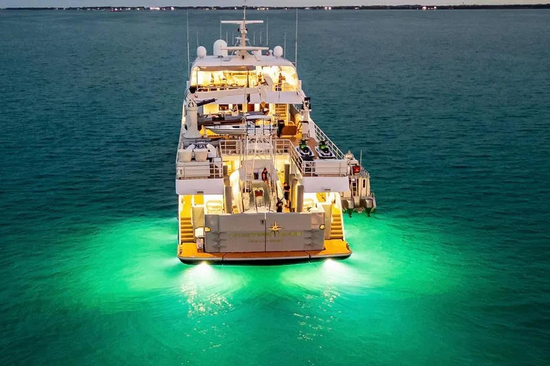 Slide: The Image of Luxurious 2011 C & G Boatworks Explorer yacht illuminated on serene ocean waters. - 91