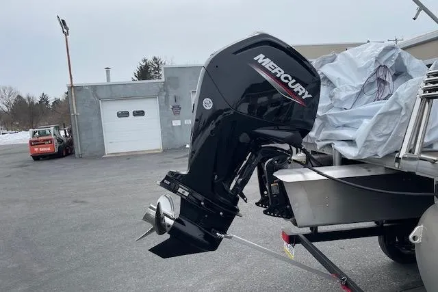 Slide: The Image of 2023 Sun Tracker Party Barge 20 DLX with Mercury outboard motor in a parking lot. - 4