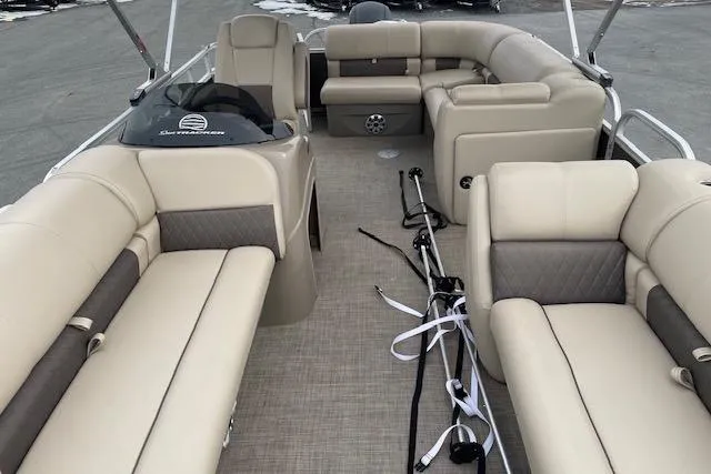 Slide: The Image of 2023 Sun Tracker Party Barge 20 DLX interior with beige seating and spacious layout. - 8