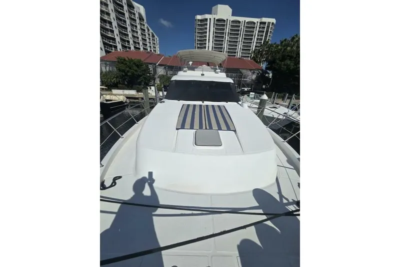 Slide: The Image of 2009 Grand Harbour 66 Motoryacht docked near high-rise buildings. - 12