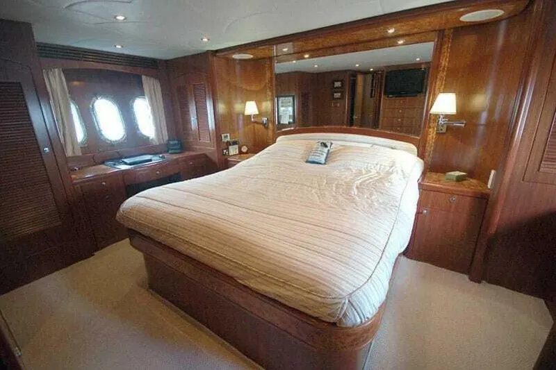 Slide: The Image of Luxurious bedroom interior of 2009 Grand Harbour 66 Motoryacht with wood paneling and large bed. - 13