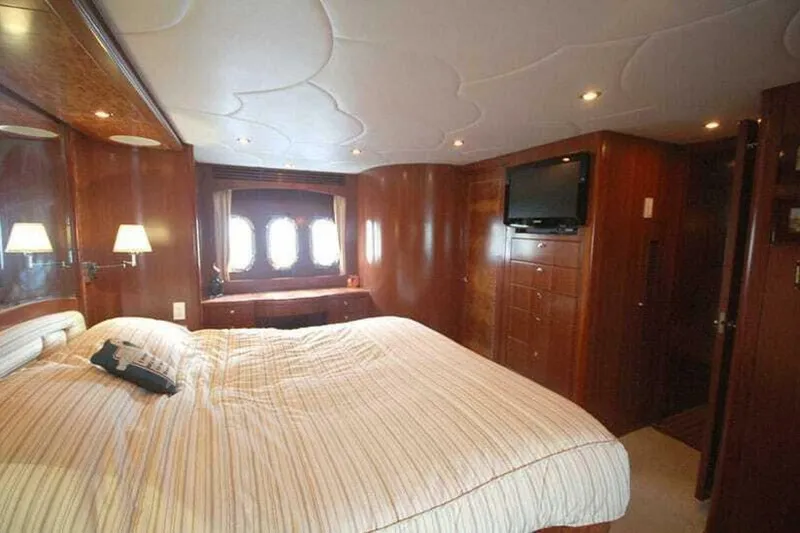 Slide: The Image of Luxurious bedroom interior of 2009 Grand Harbour 66 Motoryacht with wood paneling and cozy lighting. - 14