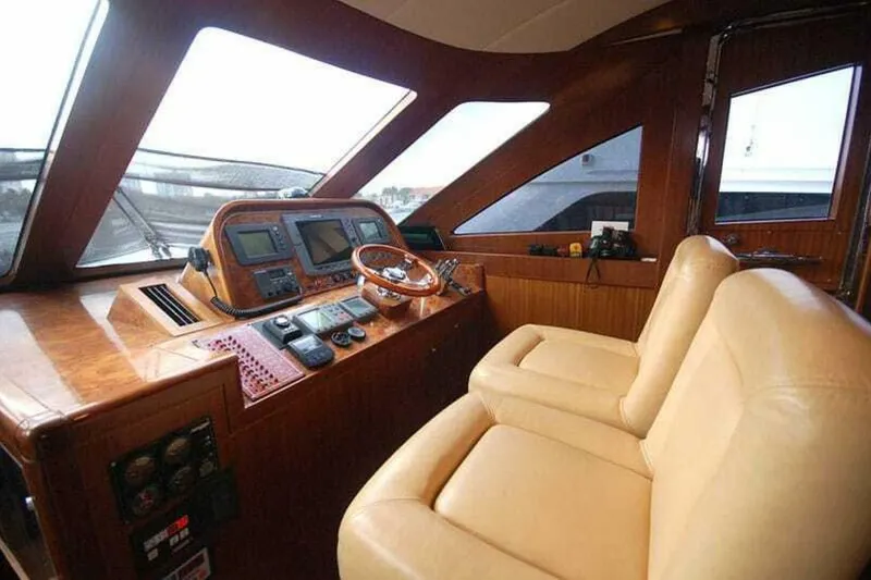 Slide: The Image of Luxurious helm of 2009 Grand Harbour 66 Motoryacht with leather seats and navigation equipment. - 16