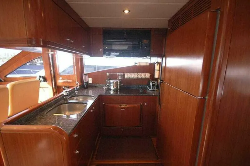 Slide: The Image of Luxurious kitchen interior of 2009 Grand Harbour 66 Motoryacht with wooden cabinetry and modern appliances. - 18