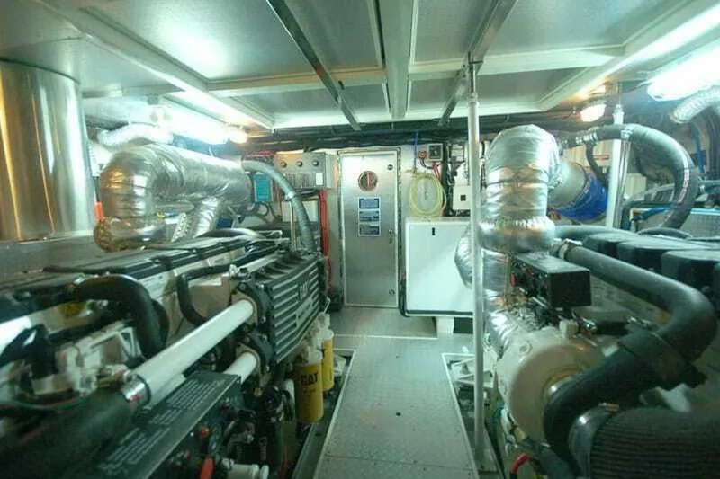 Slide: The Image of Engine room of 2009 Grand Harbour 66 Motoryacht, featuring complex machinery and piping. - 19