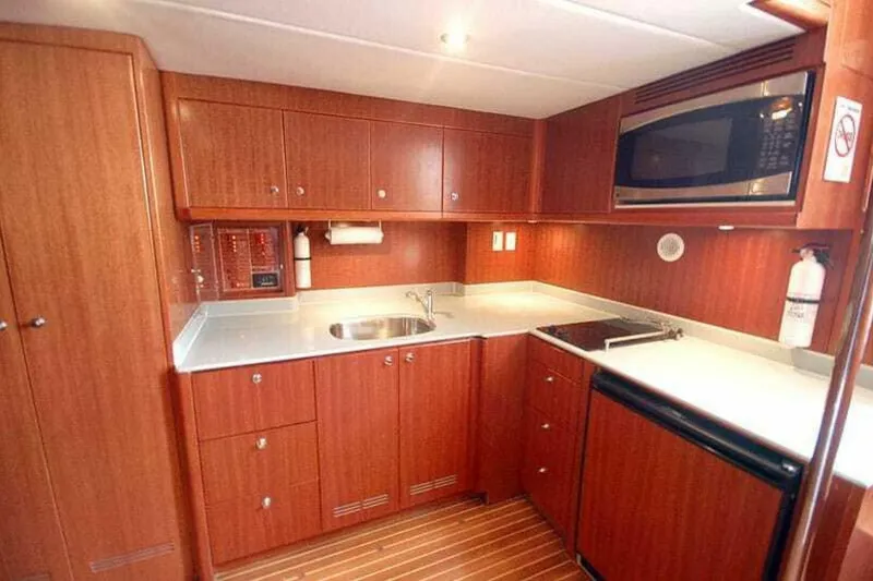 Slide: The Image of Luxurious kitchen interior of 2009 Grand Harbour 66 Motoryacht with wood cabinetry and modern appliances. - 21