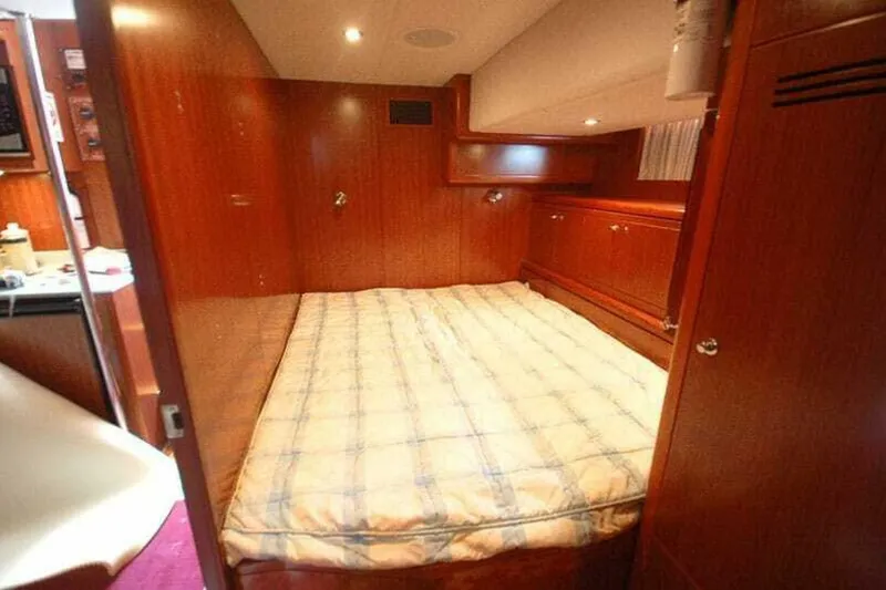 Slide: The Image of Luxurious bedroom interior of 2009 Grand Harbour 66 Motoryacht with wood paneling and cozy bed. - 25