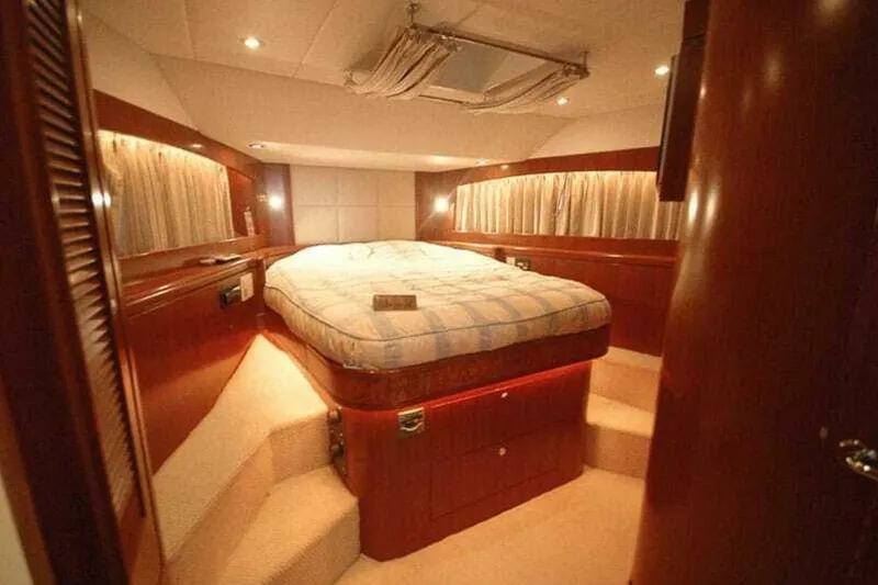 Slide: The Image of Luxurious bedroom interior of 2009 Grand Harbour 66 Motoryacht with elegant wood finishes. - 27