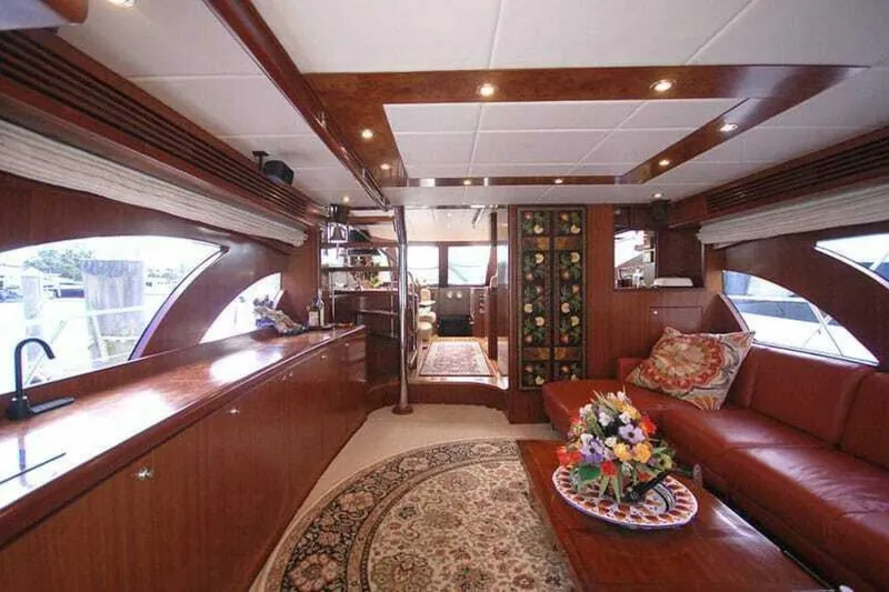 Slide: The Image of Luxurious interior of 2009 Grand Harbour 66 Motoryacht with elegant wood finishes and floral decor. - 28