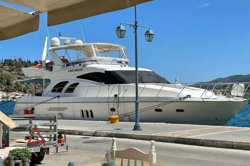 Slide: The Image of 2009 Grand Harbour 66 Motoryacht docked at a scenic waterfront location. - 3