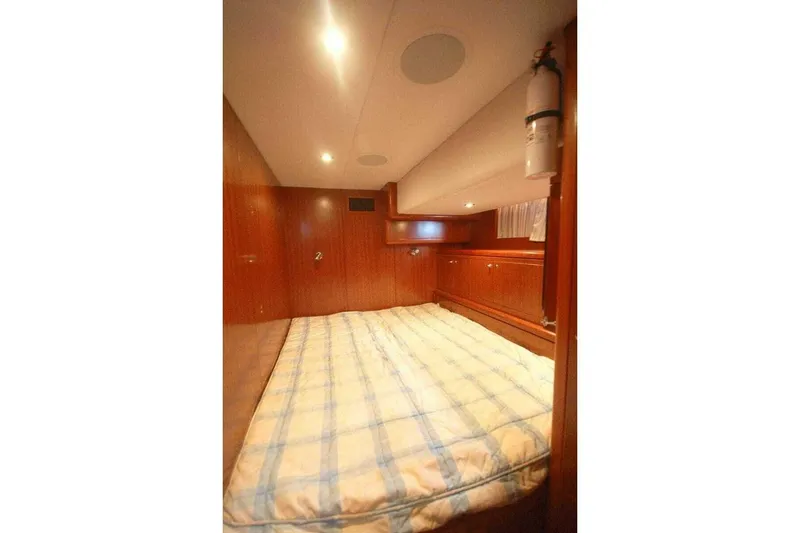 Slide: The Image of Luxurious cabin interior of 2009 Grand Harbour 66 Motoryacht with wood paneling and cozy bed. - 33