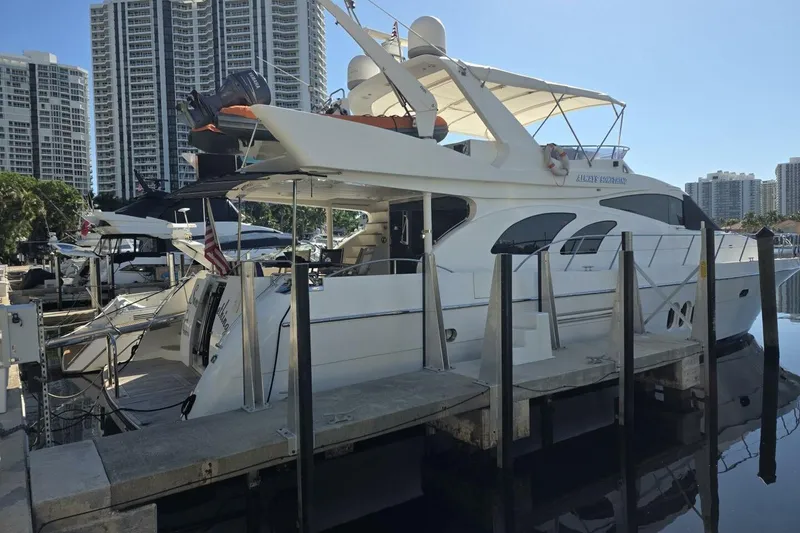 Slide: The Image of 2009 Grand Harbour 66 Motoryacht docked at marina with city skyline background. - 6