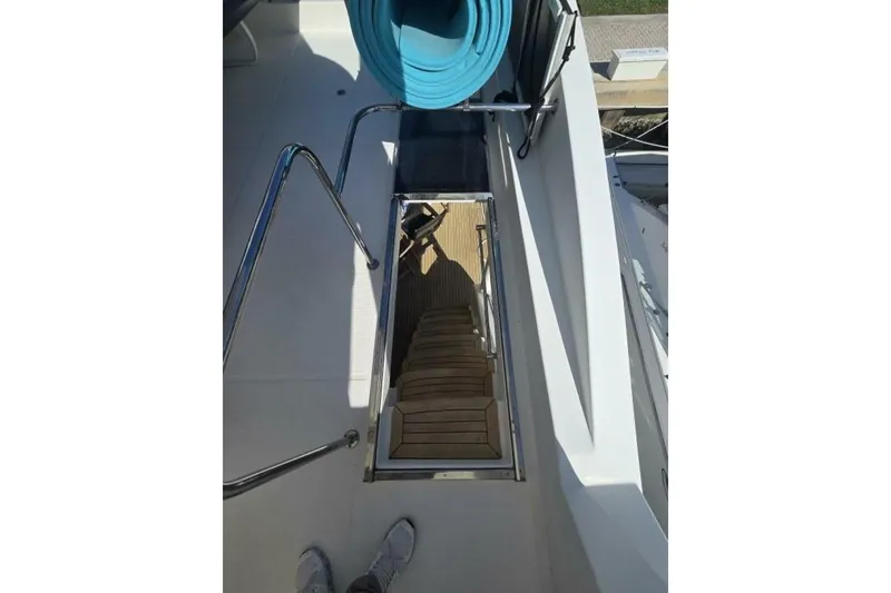 Slide: The Image of Staircase on 2009 Grand Harbour 66 Motoryacht, featuring teak steps and stainless steel railings. - 9