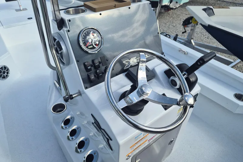 Slide: The Image of 2026 Xpress H24B Bay boat console with steering wheel and control panel. - 5