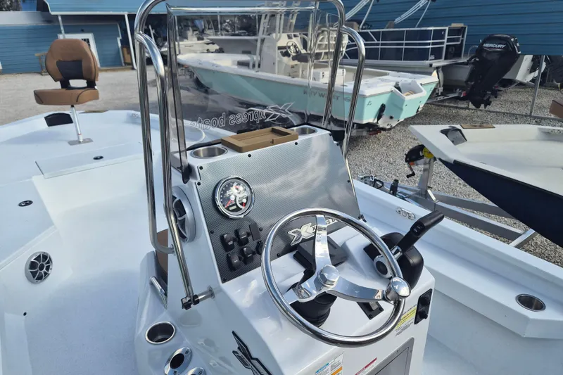 Slide: The Image of 2026 Xpress H24B Bay boat dashboard with steering wheel and controls. - 6