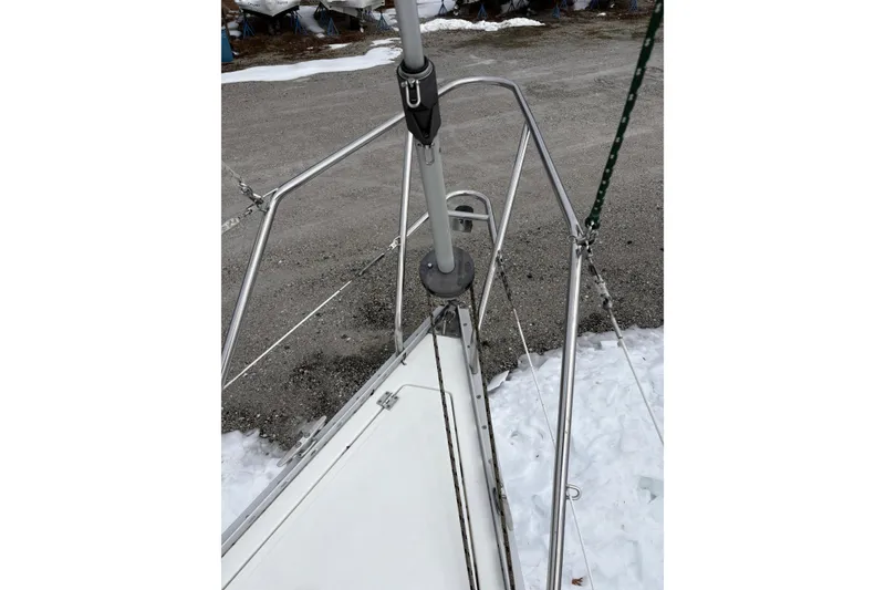 Slide: The Image of Bow of 1988 Hunter 28.5 sailboat with stainless steel railing in snowy setting. - 12