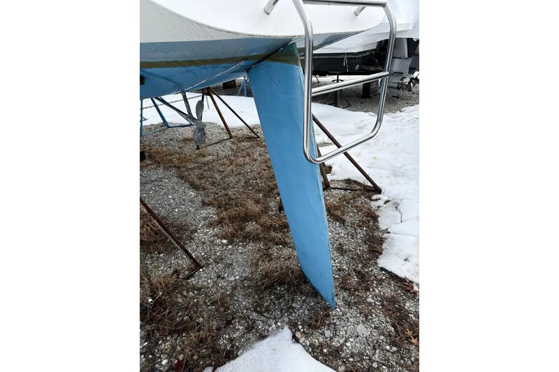 Slide: The Image of 1988 Hunter 28.5 sailboat keel and ladder on snowy ground. - 13