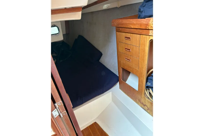 Slide: The Image of Interior cabin of 1988 Hunter 28.5 sailboat with wooden storage and bed. - 5