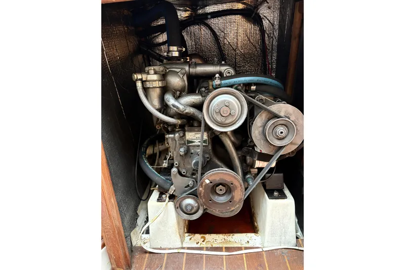 Slide: The Image of 1988 Hunter 28.5 sailboat engine compartment with visible belts and hoses. - 7
