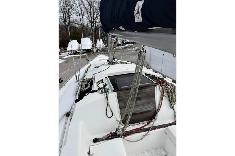 Slide: The Image of 1988 Hunter 28.5 sailboat deck with rigging and snow-covered surroundings. - 9