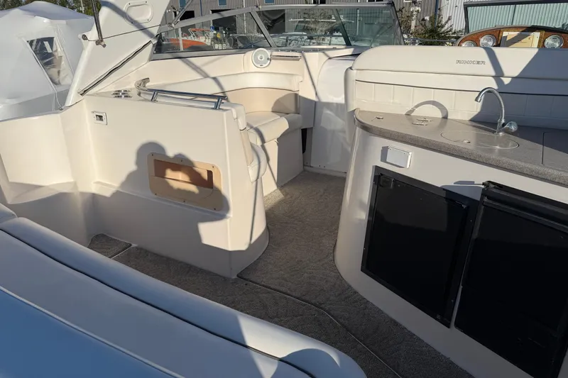 Slide: The Image of 2007 Rinker EX 370 boat interior with seating, kitchenette, and storage compartments. - 10