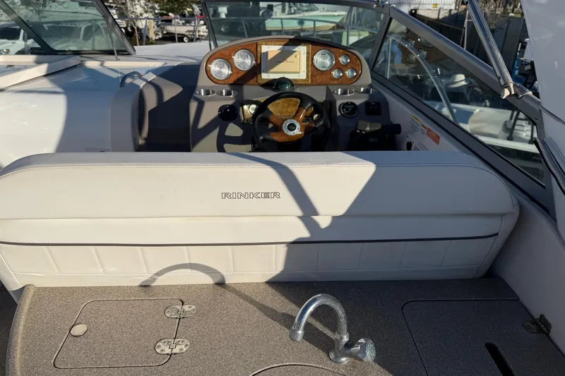 Slide: The Image of 2007 Rinker EX 370 boat interior with steering wheel and dashboard controls. - 12