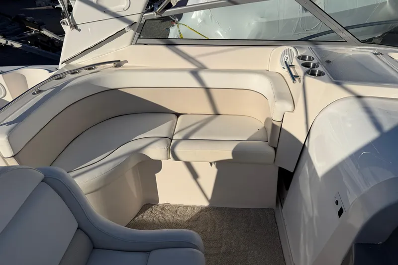 Slide: The Image of 2007 Rinker EX 370 boat interior with beige seating and cup holders. - 15