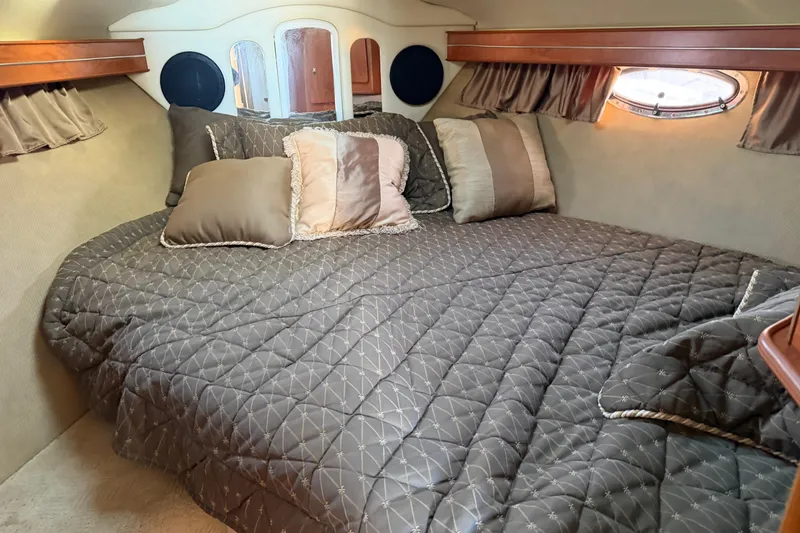 Slide: The Image of Luxurious cabin interior of 2007 Rinker EX 370 with plush bedding and elegant decor. - 23