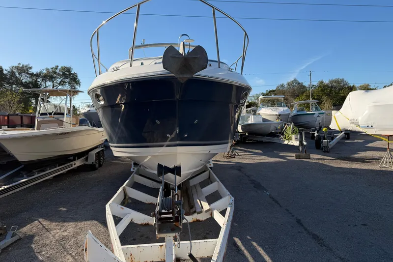 Slide: The Image of 2007 Rinker EX 370 boat on trailer in a marina, surrounded by other boats. - 3