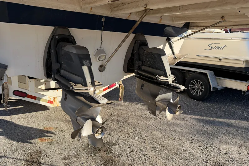 Slide: The Image of 2007 Rinker EX 370 boat with dual propellers on a trailer. - 33