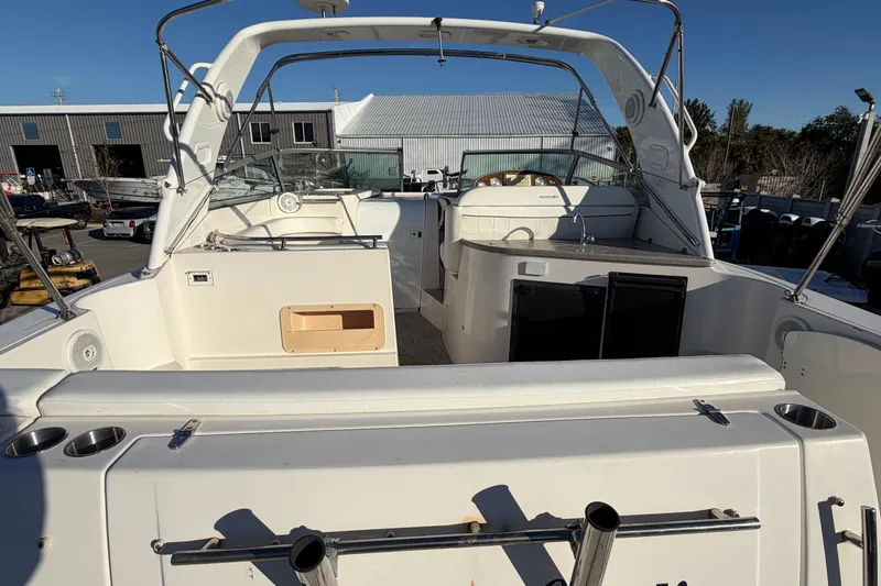 Slide: The Image of 2007 Rinker EX 370 boat interior with seating and dashboard, docked outdoors. - 8